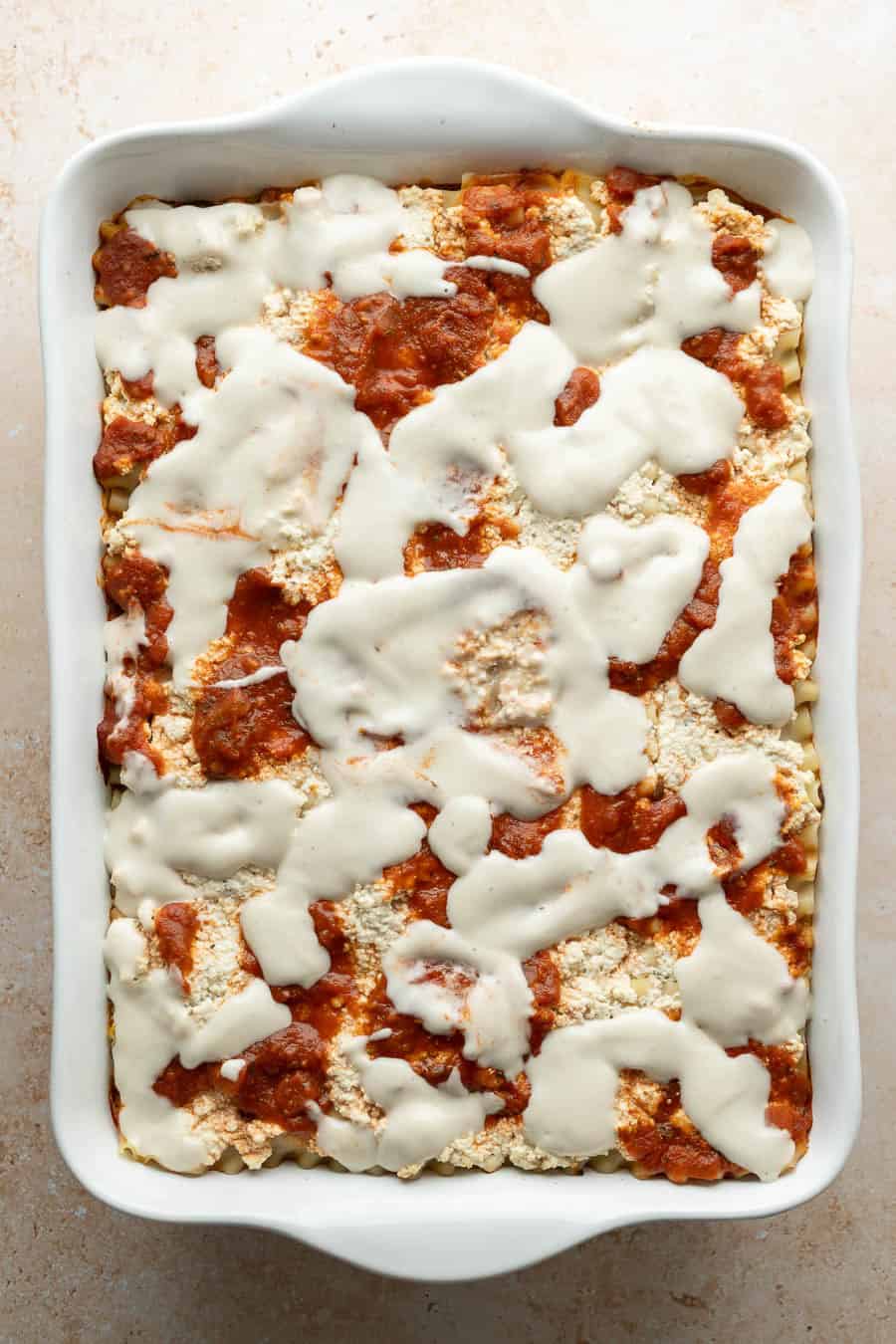 After 45 minutes in the oven, the lasagna is topped with homemade vegan mozzarella cheese before being browned.