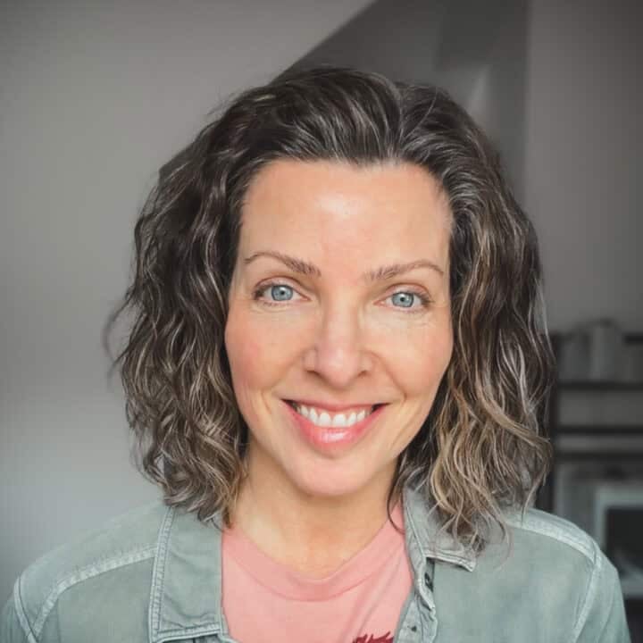 Lori Rasmussen, author of My Quiet Kitchen, standing in her kitchen.
