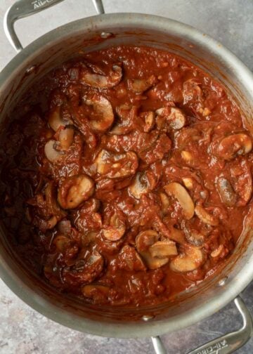After simmering for 25 minutes, the thickened tomato sauce clings to the mushrooms.