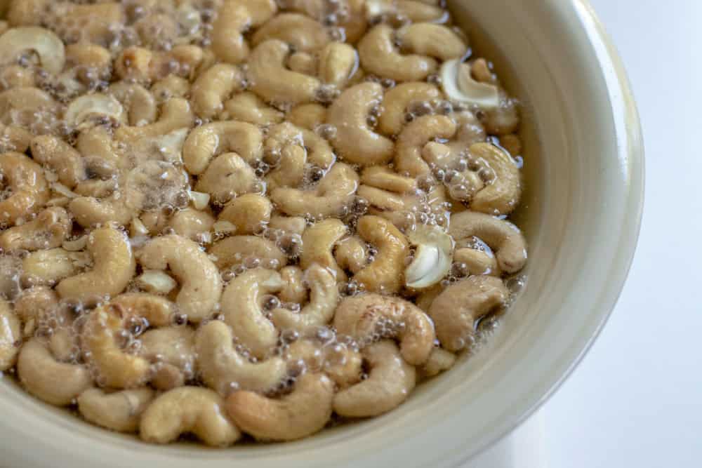 Cashews in a bowl soaking in beer.