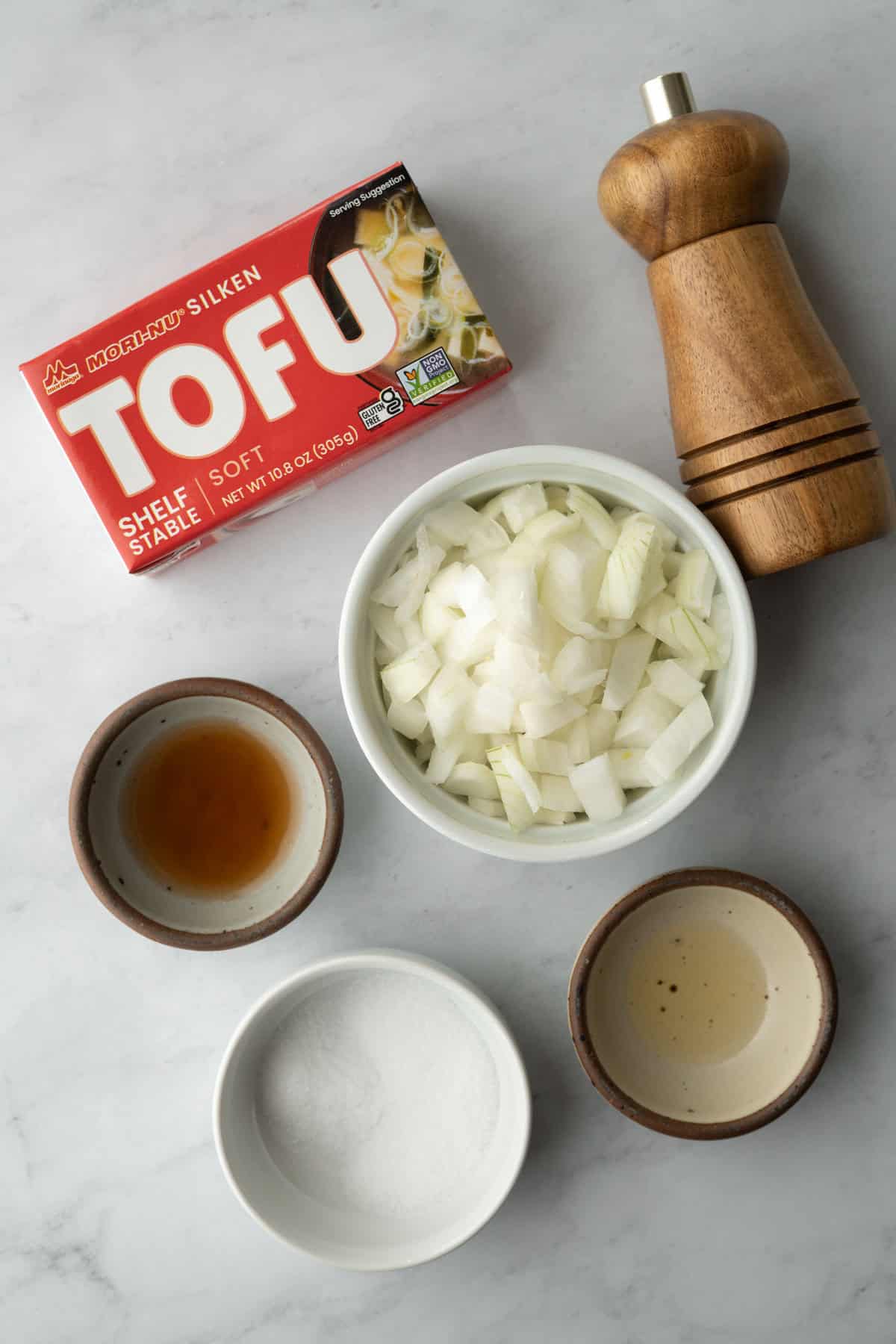 The ingredients needed to make the dressing resting on a white countertop.