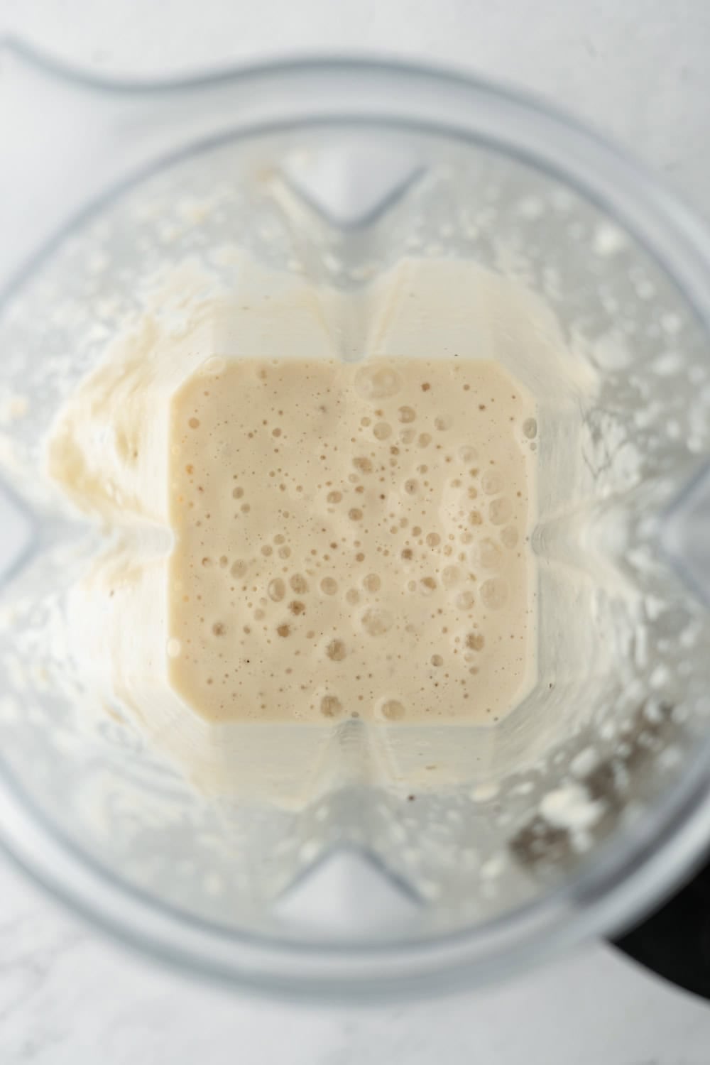 The blended creamy onion dressing inside the blender.