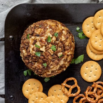 A vegan cheese ball coated in nuts and tempeh bacon.