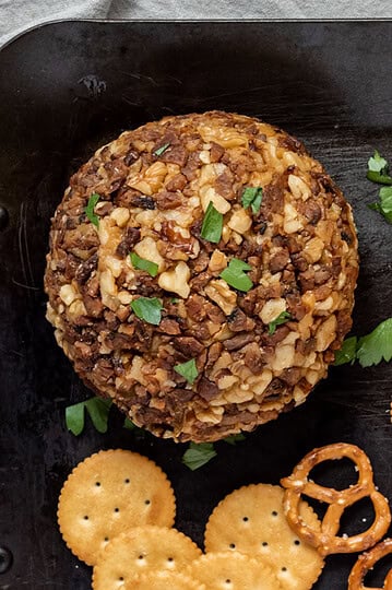 A vegan cheese ball coated in nuts and tempeh bacon.