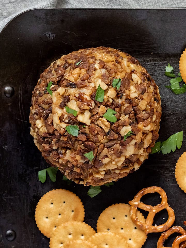 A vegan cheese ball coated in nuts and tempeh bacon.