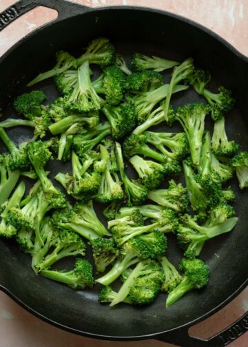 Saut&eacute;ing broccoli to add depth and flavor to the casserole.