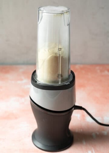 Blending cheese powder in a small personal blender.