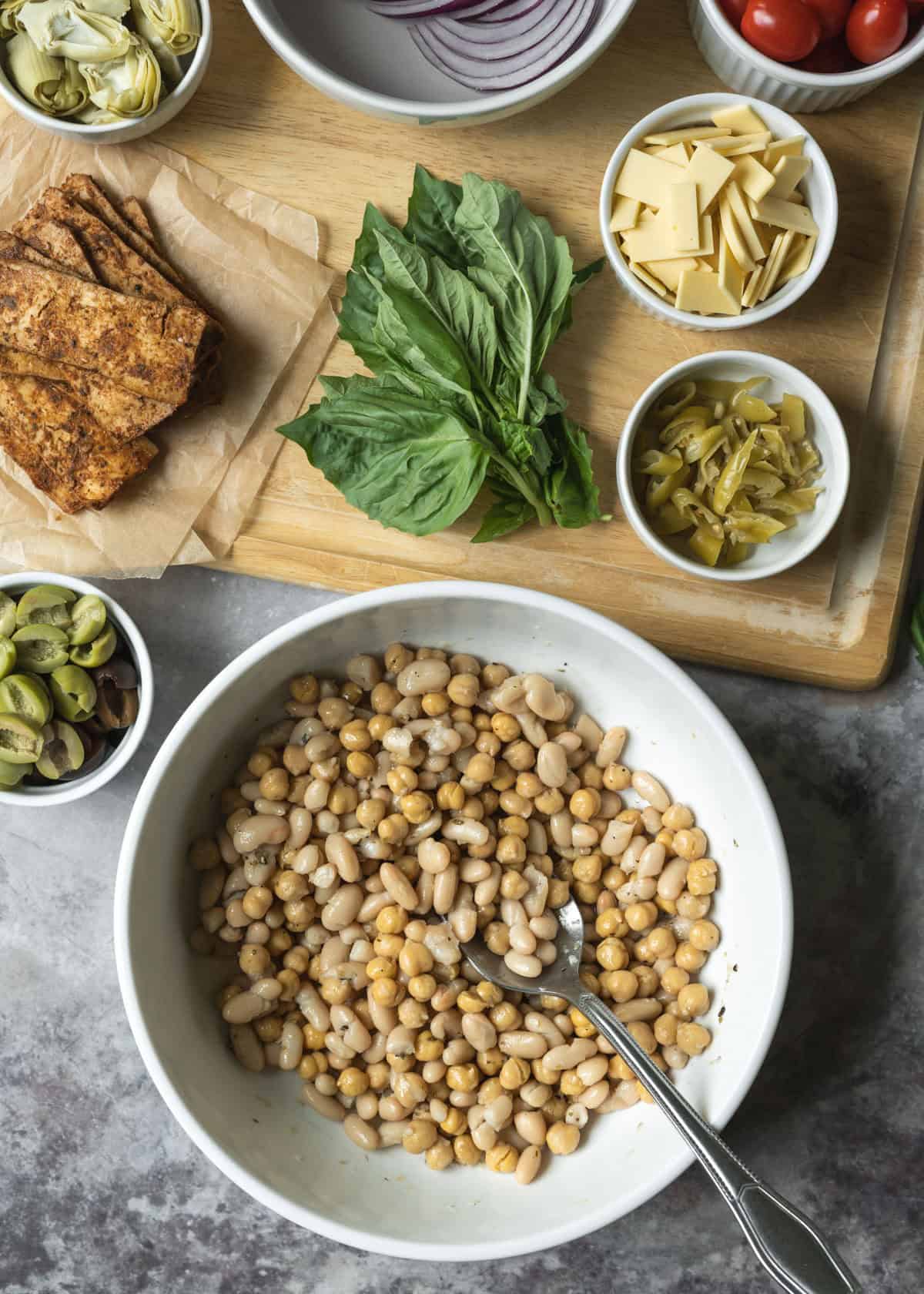The various ingredients for bean salad chopped and measured and ready to be tossed with dressing.