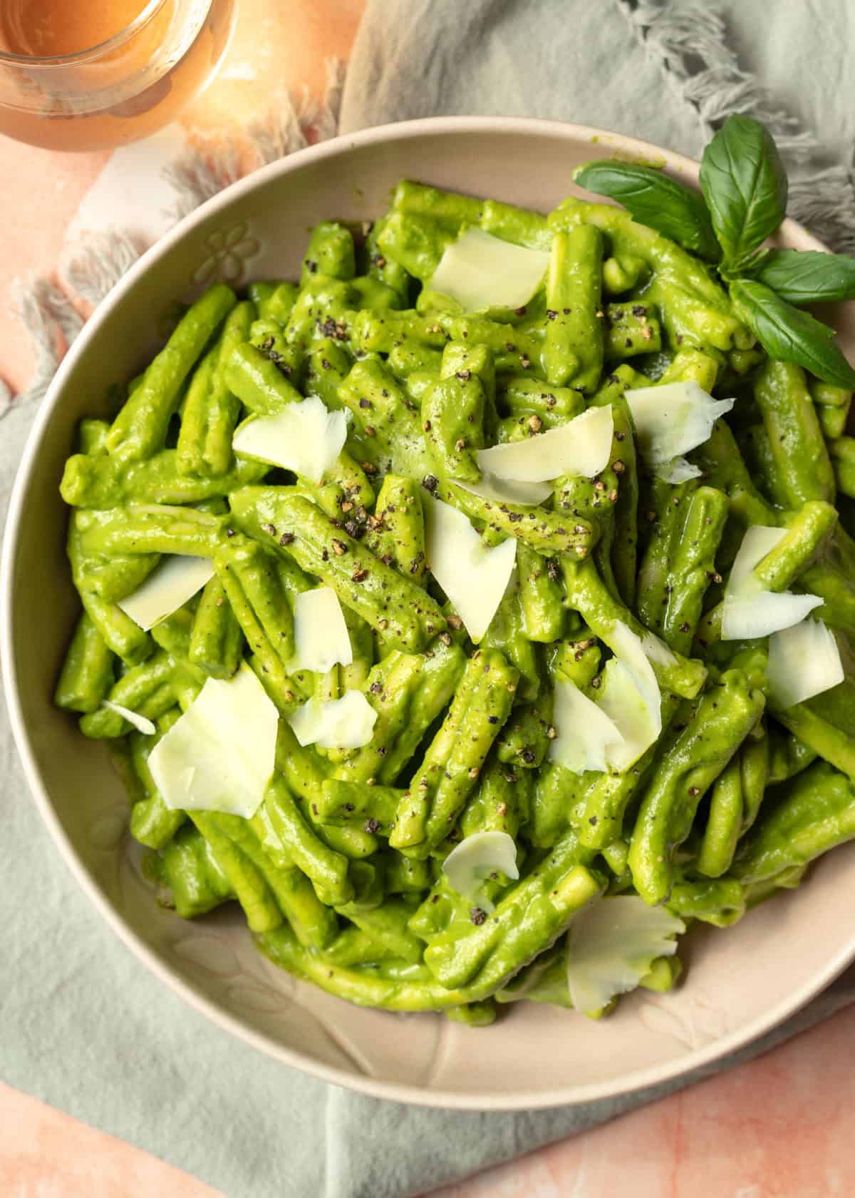 A bowl of pasta coated in creamy green goddess pasta sauce.