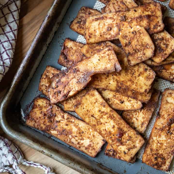 Tofu salami on a baking sheet.
