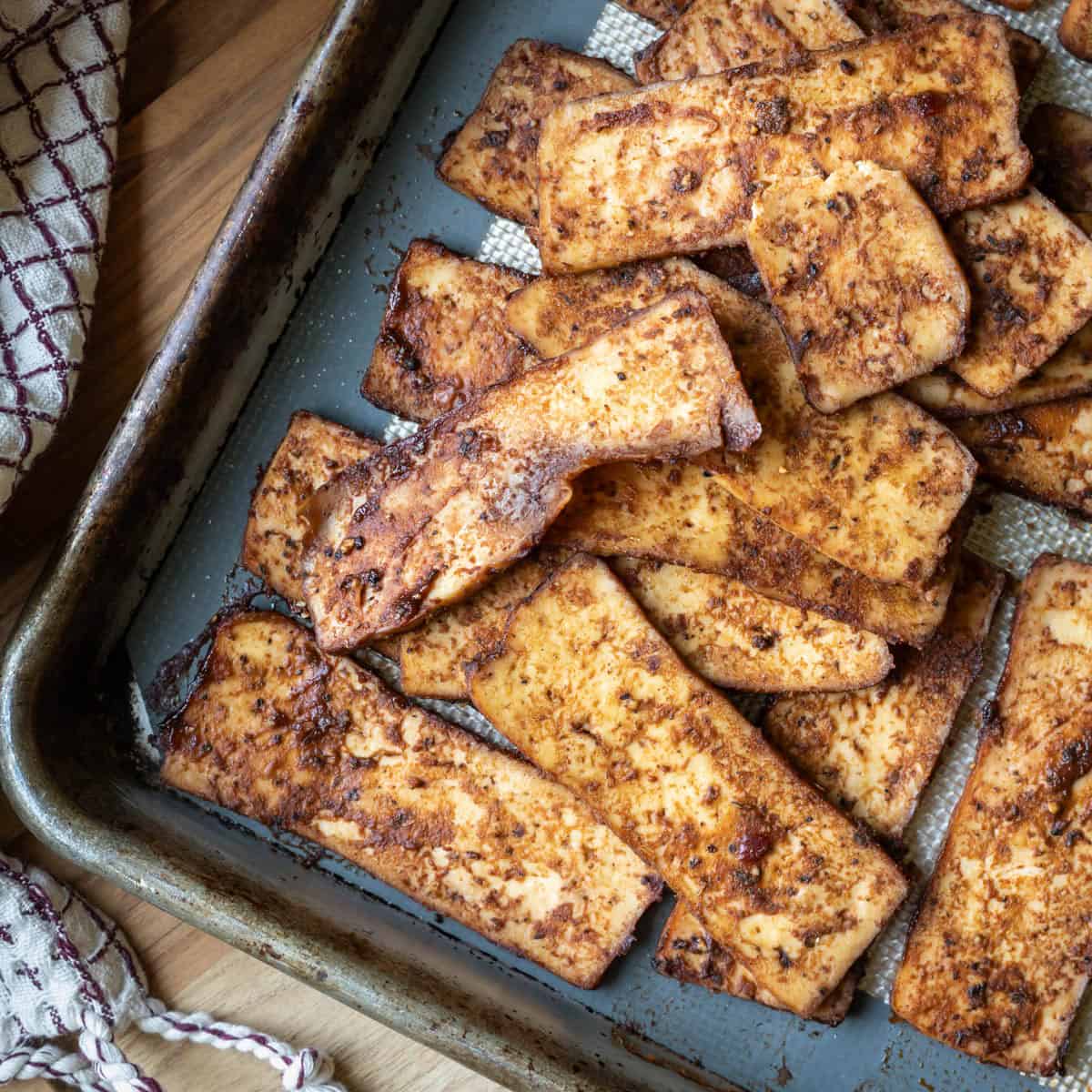 Tofu salami on a baking sheet.