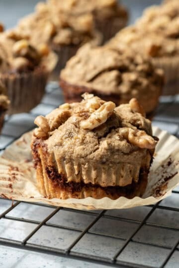 Muffins with cinnamon swirl and walnuts on top.