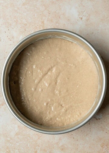 Cake batter poured into pan over the apple-walnut mixture.