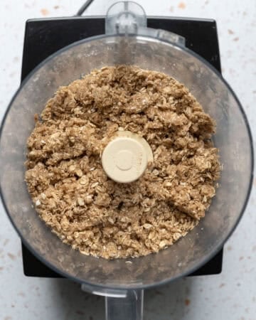 Processing oats, almond, flour, and sugar for the press-in crust.